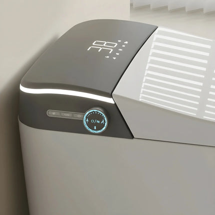 Modern sleek gray and white electronic appliance with digital display and control knob